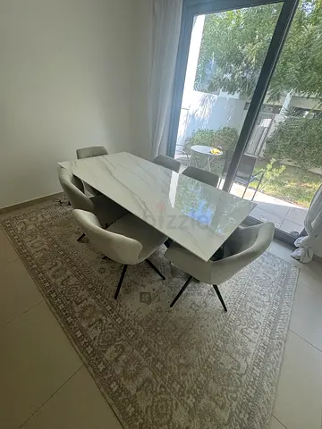 Dining table with 6 chairs and large patterned rug - good condition