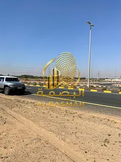 For Sale in Emirates Industrial City: Prime Land on a Main Road, with 97 meters of frontage — 41,1