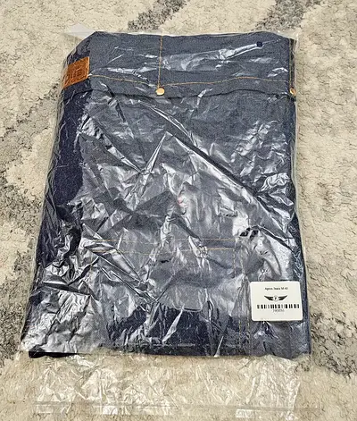Brand new denim jeans (sealed) apron- size not specified