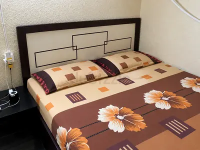 King bed frame with mattress and floral bedsheet - good condition