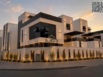 فيلا فاخرة تقع على زاوية للبيع في منطقة "الحليو 2" بعجمان؛ تُسلَّم جاهزة للسكن (تسليم مفتاح) وشاملة لكافة التجهيزات، وتتميز بتصميم عصري وتشطيبات راقية