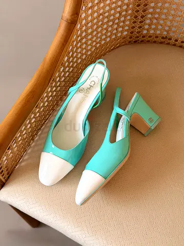 Mint green slingback block heel shoes with white cap toe — size not specified
