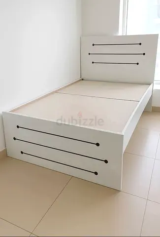 Single white wooden bed frame with headboard and storage-ready base