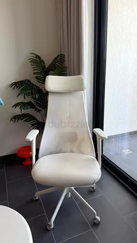 White ergonomic swivel office chair with headrest from ikea - good condition. Bought 2k aed
