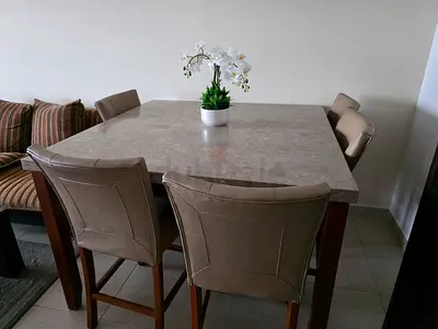 Marble-top dining table with 6 cushioned chairs - good condition