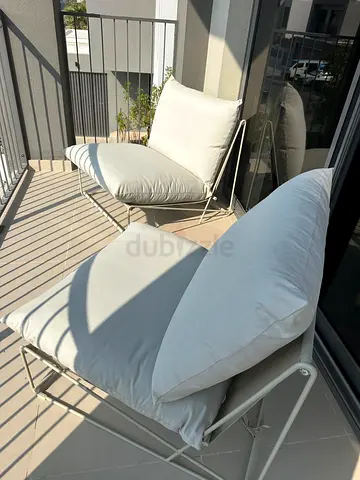 Pair of outdoor lounge chairs with cushions - light beige