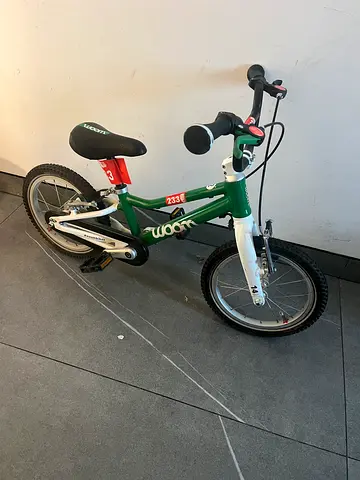 Green children's 14-inch Woom bike - great condition