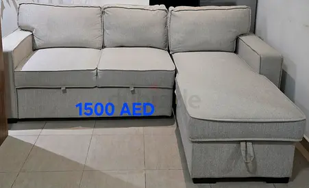 Light grey L-shaped fabric sofa with storage - good condition
