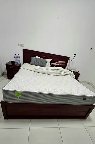 King wooden bed frame with fresh spotless 26 cm high end mattress and bedside tables