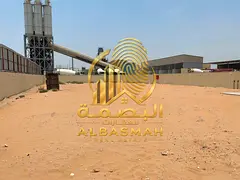 A fenced yard for rent in Sajaa Industrial Area, located directly on the main road; area is 20,000 s