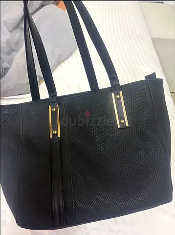 Black textured tote bag with gold trim