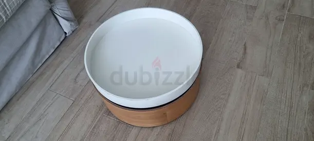 Round wooden coffee table with removable white tray top