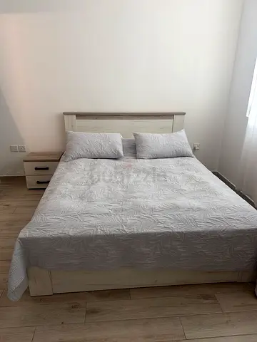 Queen bed frame with headboard and two bedside drawers - light wood