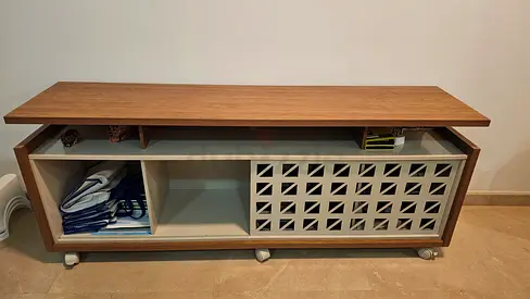 Low wooden TV cabinet / media console with sliding patterned door on casters