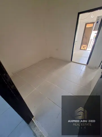 One-bedroom apartment with a living room for rent in Al Butina, Sharjah; includes a balcony and bat