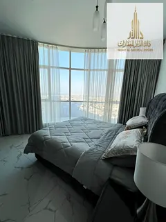 For monthly rent: a beautiful 3-bedroom apartment with a living area and a direct sea view.