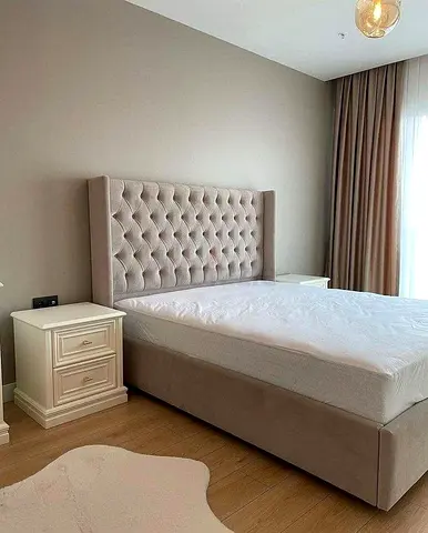 Upholstered wingback double bed with tufted headboard