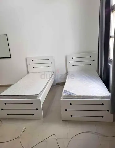 Pair of white single beds with storage — good condition