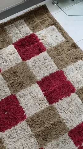 Used shaggy checkered rug - brown, beige and maroon.