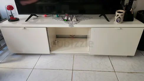 Low white TV cabinet with storage compartments