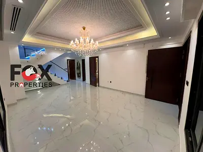 Modern Villa for Sale in Al Helio 2, Ajman. 4 master bedrooms, maid’s room, majlis, 2 kitchens, rooftop and 4-car parking. Plot 3,014 sq. ft., built-u