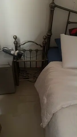 Metal bed frame and bedside magazine rack — good condition