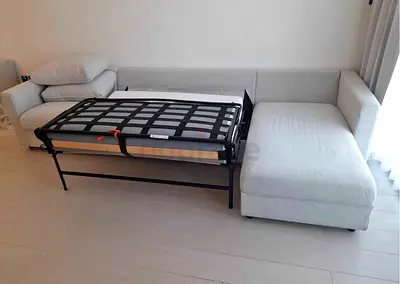 Light beige L-shaped sofa bed with chaise (pull-out bed frame visible) — good condition vimle