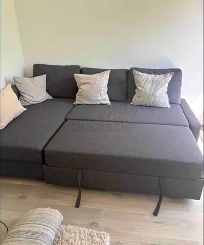 Gray L-shaped Sofa Bed with Cushions - Good Condition