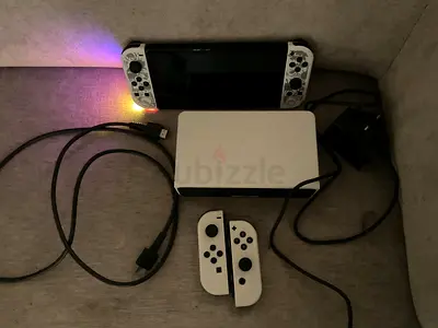 White Nintendo Switch OLED with dock and Joy‑Cons