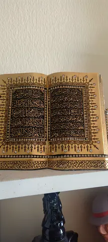 Small decorative Arabic Quran with gold-ink pages