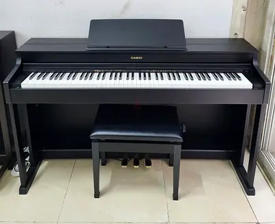 The Casio Celviano AP-470BK is an 88-key digital upright piano designed to emulate the touch and