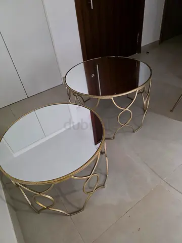 Pair of round glass-top gold side tables