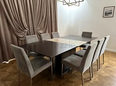 Dark wood extendable dining table with 8 grey upholstered chairs - good condition