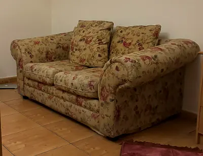 Two-seater floral fabric sofa, good condition