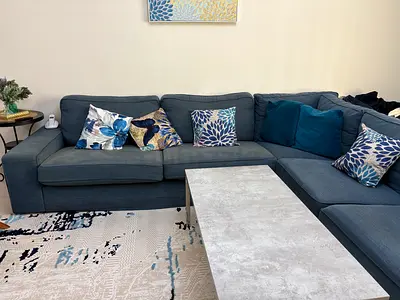 Large blue L-shaped sectional sofa in good condition