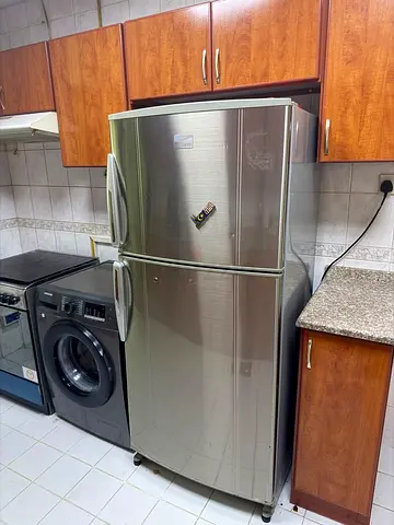 Silver double-door refrigerator in good working condition