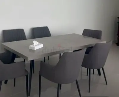 Modern grey dining table with 6 upholstered chairs