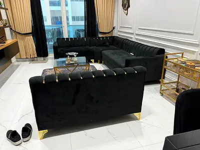 L-shaped black velvet sectional sofa with gold legs - excellent condition