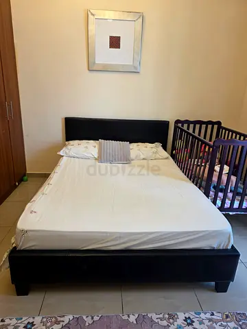 Queen size black faux leather bed frame with headboard - good condition