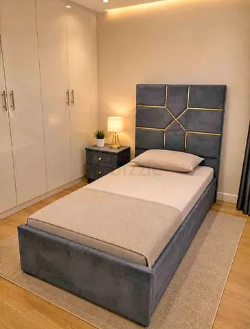 Single upholstered bed frame with padded headboard and storage base - grey