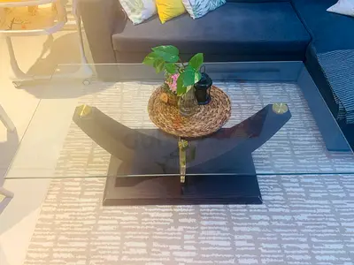 Glass Top Coffee Table with Dark Wood Base and Brass Accents