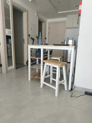 Compact kitchen island with two wooden stools — white and natural finish