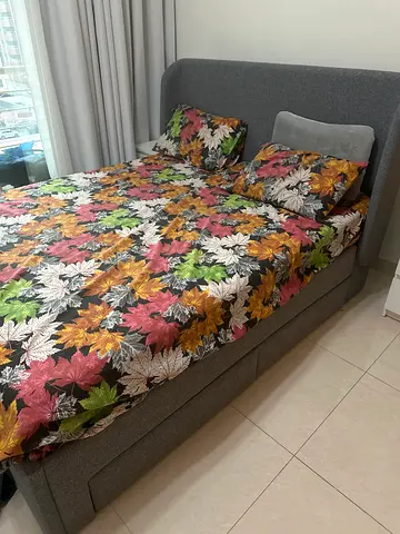 Grey fabric queen size bed with floral mattress cover (good condition)