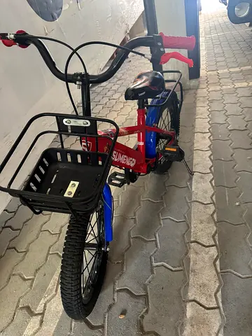 Kids' blue and red bicycle with front basket - good condition