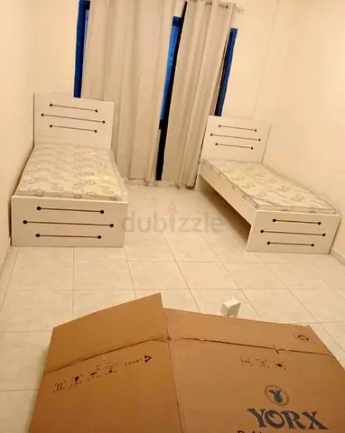 Pair of single white wooden beds with mattresses - good condition