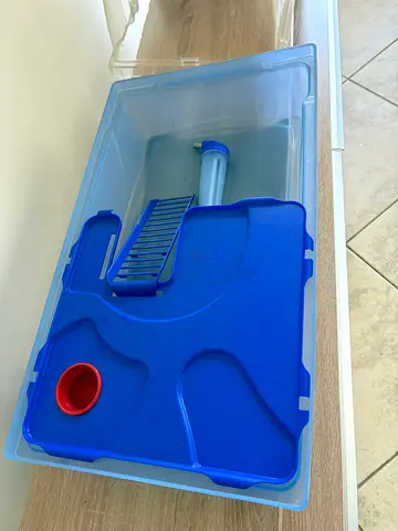 Clear plastic hamster box with blue insert and some hamster toys — good condition