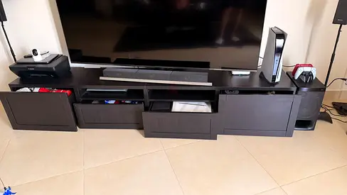 Dark wood TV entertainment unit with storage drawers and open shelves