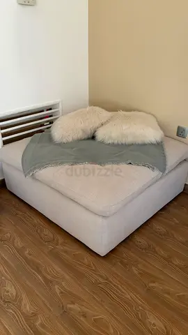 Large beige corner ottoman / footstool — good condition