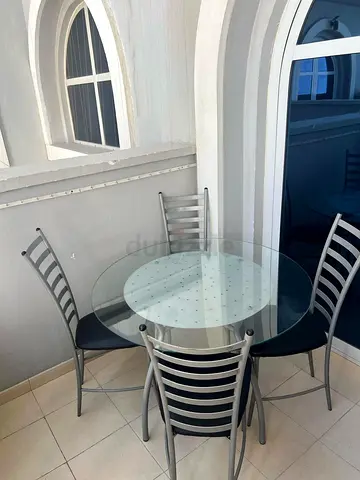 Compact 4-Seater Round Glass Dining Table with Metal Chairs