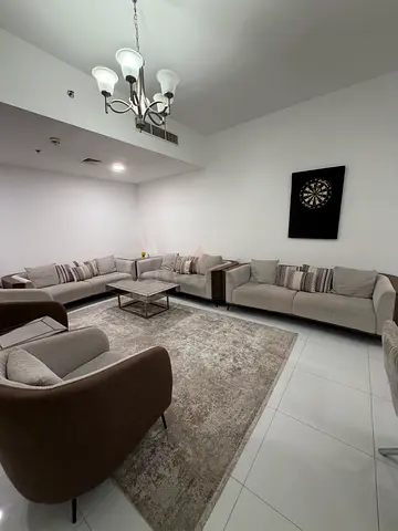 Large L-shaped fabric corner sofa with ottoman - neutral beige